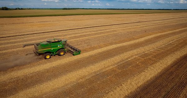 John Deere combine harvesting winter grains in Ukraine