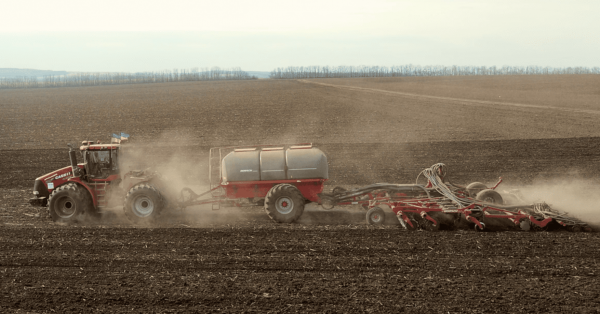A HORSCH seed drill towed to a CASE IH tractor is planting spring crops in CFG field in Ukraine. March 2023