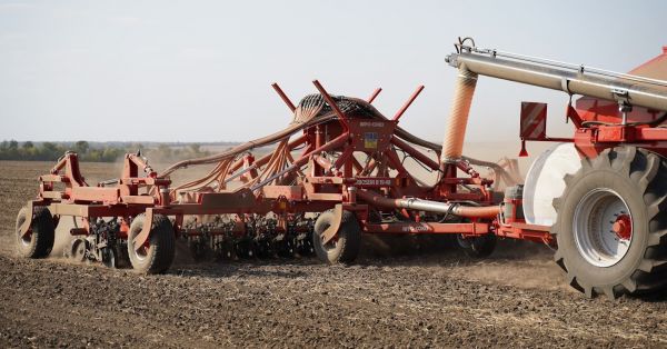 A seeder towed to a tractor in a field in Ukraine