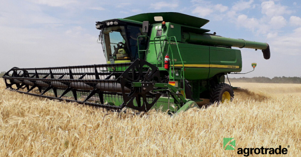 John Deere harvester is cutting winter barley in Agrotrade's field in Kharkiv region