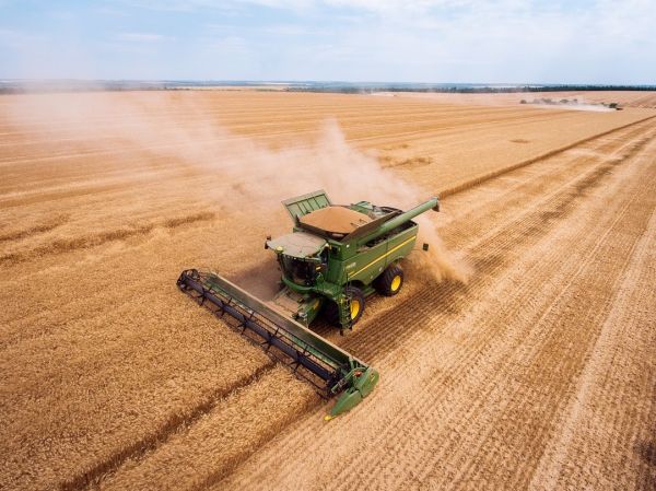 John Deere combine harvesting winter grains in Ukraine