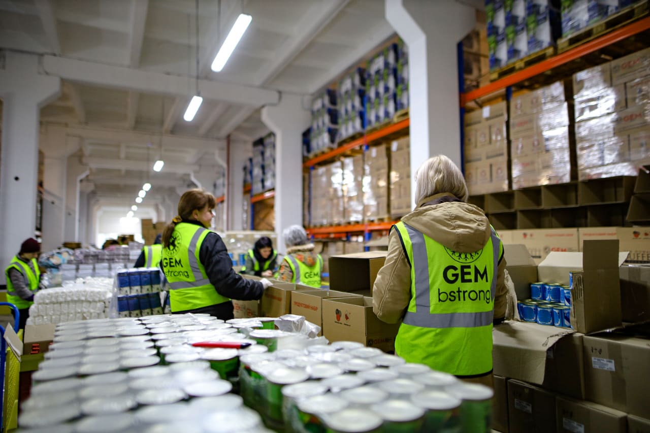 Volunteers form humanitarian food kits at one of the company's storage facilities