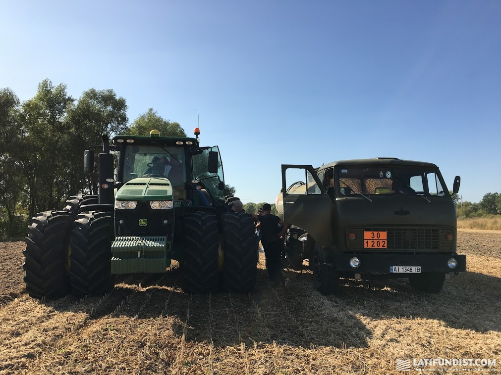 A John Deere tractor and a refueller of A.G.R. Group in a field