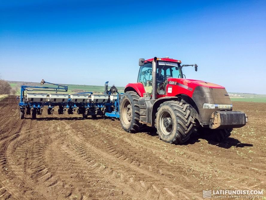 A Case IH tractor with a Kinze seeder